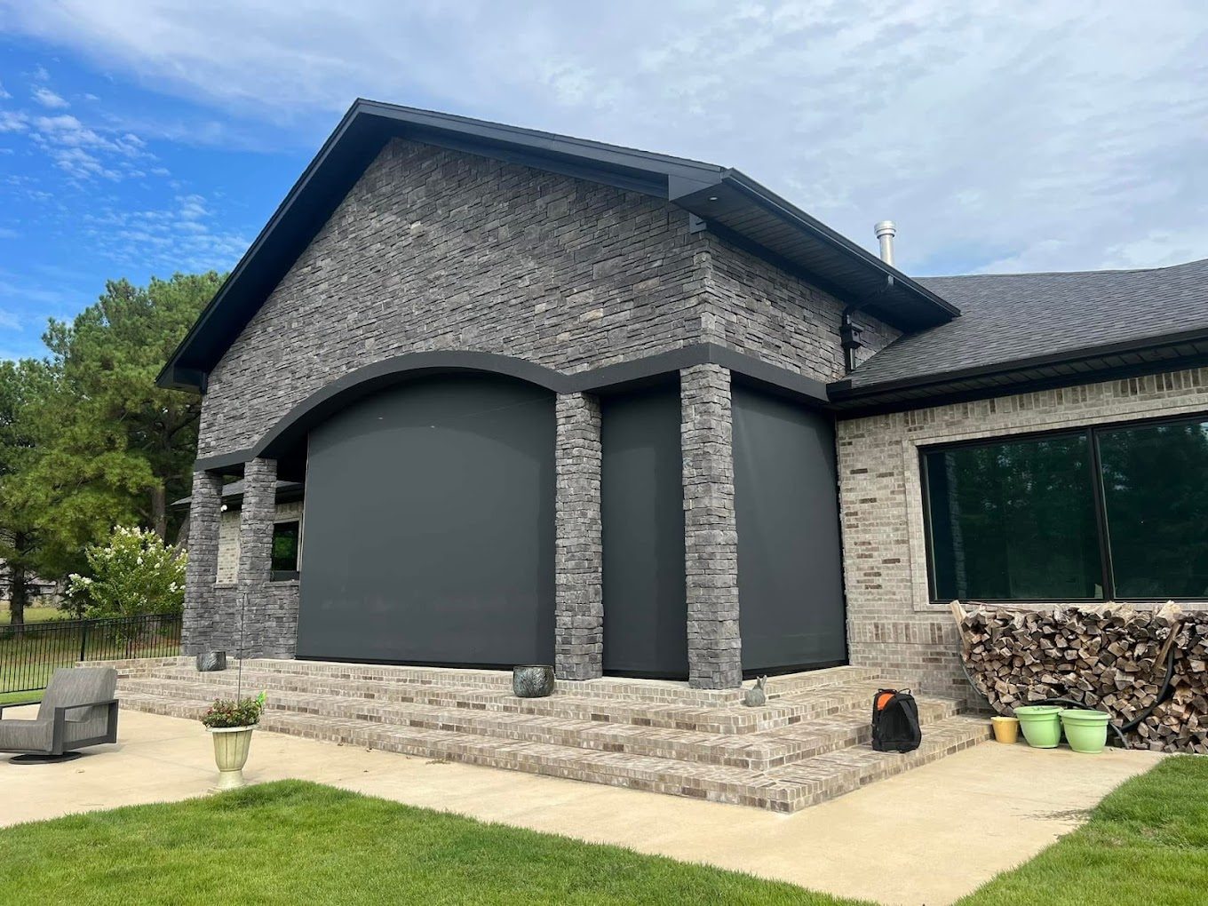 Exterior solar shades on a home’s arched windows