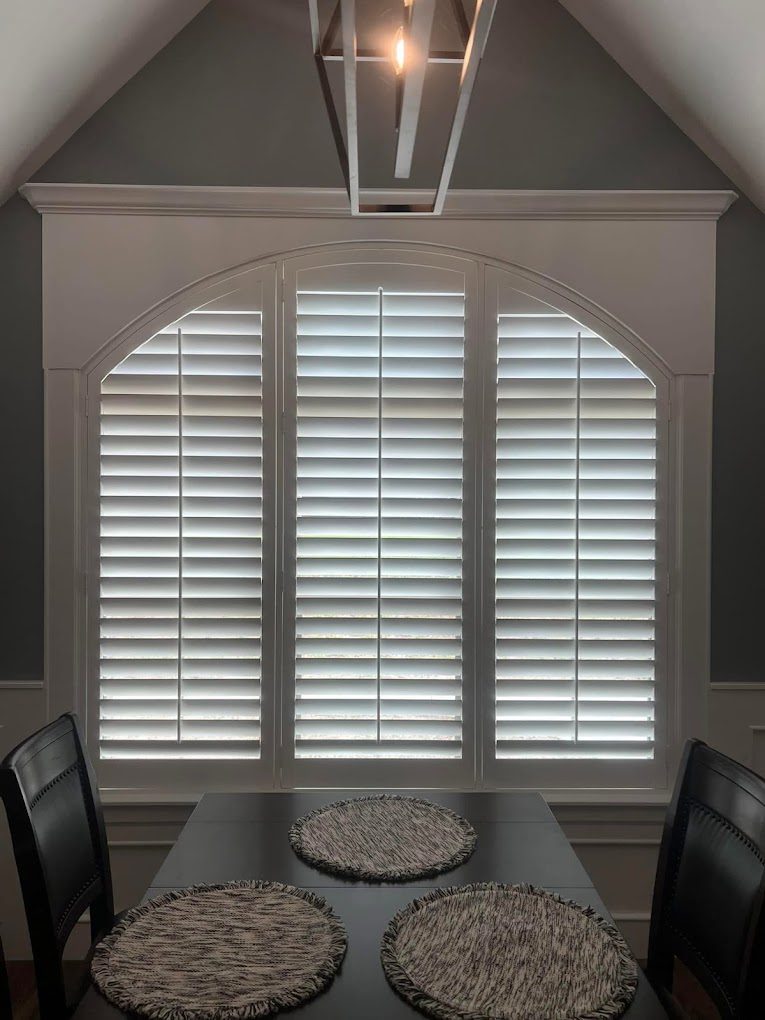 Arched plantation shutters in a dining room